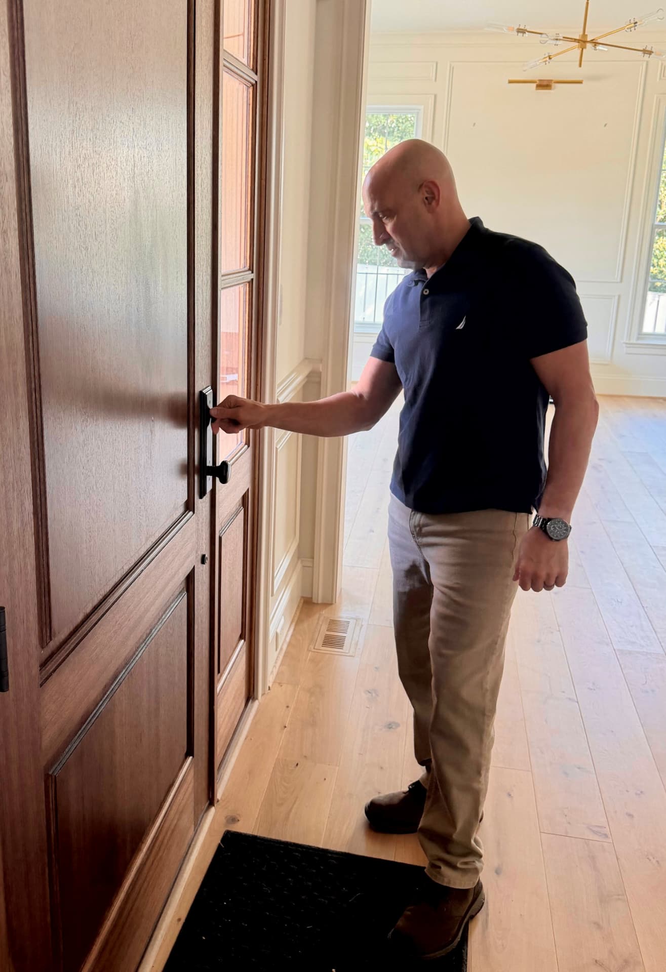 Robert checking an entry door lock