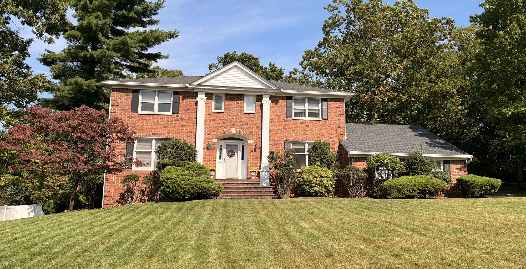 Two-story brick home with a columned front entrance