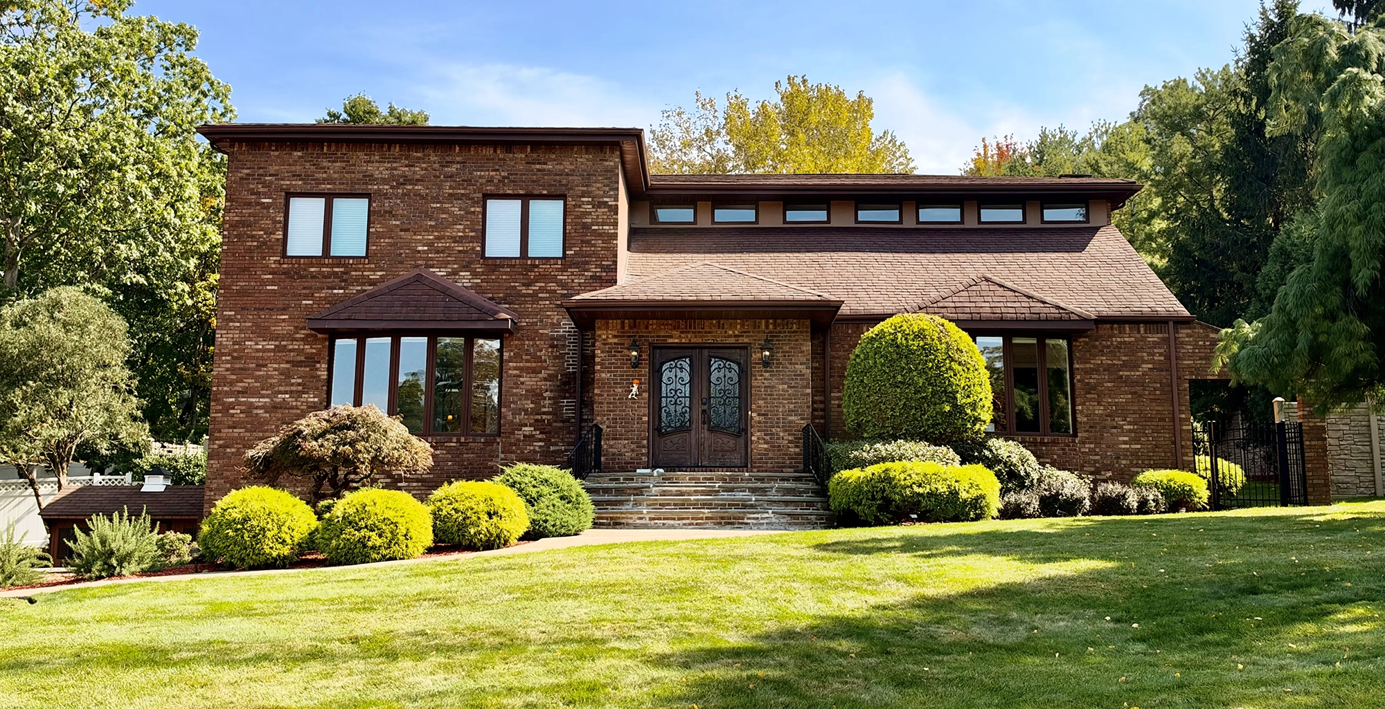 Modern multi-level brick home with stone entry steps